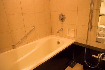 <p>The bath was big enough to relax in. It also included a shower.</p>
