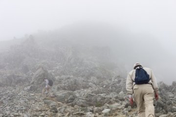 <p>Hikers have to scramble over loose scree for the last part of the climb</p>