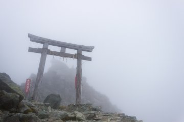 <p>The priest get barely be seen on the summit under the heavy cloud cover</p>