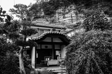 <p>The priest's residential quarters overlooked by a large hill</p>