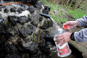 <p>You can fill water bottles from this pure mountain spring beside the road</p>