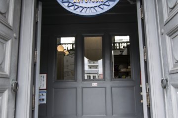 <p>The entrance into the Karakoro Art Studio. Note the dark boding entryway that leads to doors on eithers sides, this was how the building was constructed when it was the Bank of Japan.</p>