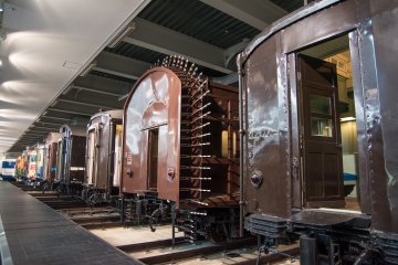 <p>Many different local trains aligned across the room</p>