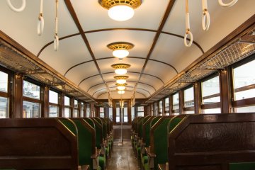 <p>Inside an old school railway train with a classic wood finish interior&nbsp;</p>