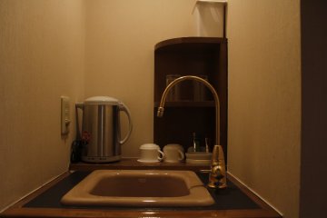 <p>The sink with the kettle and coffee maker.</p>