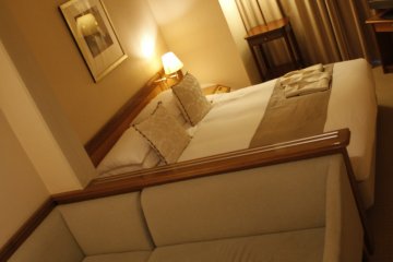 <p>The lounge area and bed.</p>