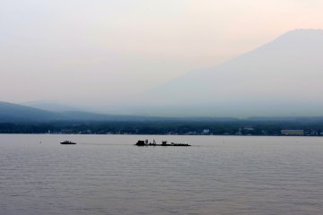 A small boat towed barges laden with fireworks onto the lake