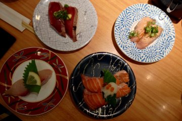 <p>Clockwise from top-left: katsu tataki, the "Mmmm," inducing aburi shio negi salmon, salmon toro and kanpachi</p>