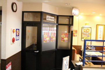 <p>An enclosed smoking area in an otherwise smoke-free restaurant</p>