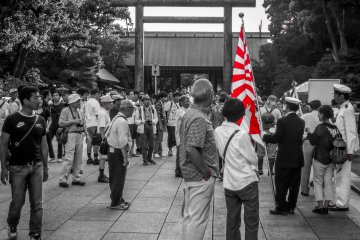 <p>When heading back into Yasukuni Shrine I could see several people hoisting the Japanese Imperial Naval flag</p>
