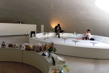 Next to the artwork is a small museum shop and caf&eacute; that is shaped like the museum, where you can take off your shoes and relax on the carpeted floor