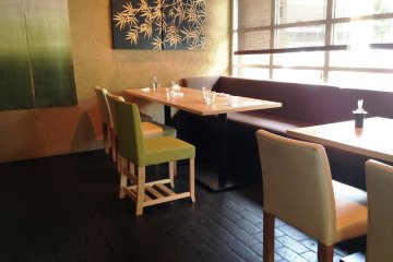 The simple matcha green chairs and bamboo prints are pleasing on the eye.