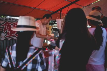 <p>A man sells crab sticks by the shrine</p>