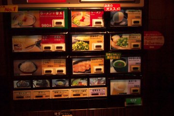 <p>Ticket machine has item names in English and Japanese, along with pictures of the item you're trying to order.</p>