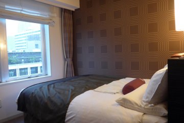 For the standard double room, you can get a good view of the busy street below from your bed.