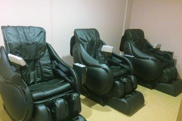<p>Three massage chairs outside of the onsen</p>