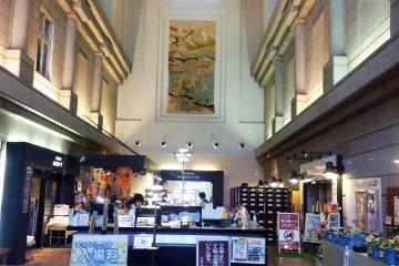 <p>The entrance hall to the hot spring and hotel. To the left is the hotel lobby, to the right is a kid's play area and straight ahead is the arcade, buffet and hot spring.</p>