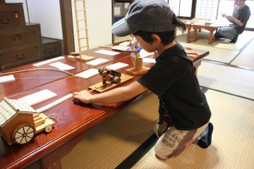 A boy playing with a sawfly toy