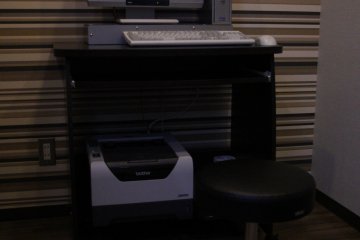 The room with a computer and a printer on the first floor