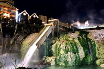 <p>Hot water pours down a wooden chute at the lower end of the the 'hot water field'</p>