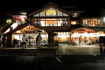 <p>On the left, lit up stairs lead to a temple, and in the foreground is a small shrine where people throw coins</p>