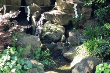<p>A small waterfalls tumbles down the far bank</p>
