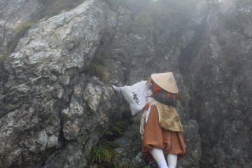<p>The first Test of Courage, climbing the 30 foot tall Kane Kane Iwa, Hanging or Crab Rock</p>