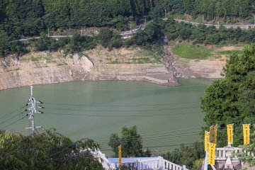 <p>Looking down on Niu-Kawakami Kamishi Shrine's original location on the opposite side of the flood control reservoir</p>