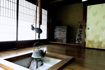 <p>An iron kettle hanging over a sunken hearth in Kikuya Inn</p>