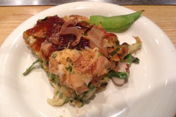 <p>A slice of scrumptious okonomiyaki topped with katsuobushi (dried bonito flakes).</p>