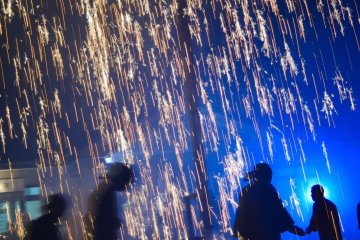 Running around beneath the blow tube fireworks as they rain down sparks.