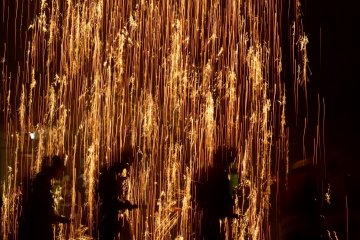 The falling gunpowder explodes as it rains down.