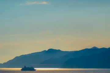 A distant ferry enjoying the clear Japanese waters