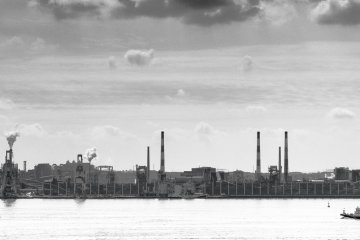 Moody scenes passing dockside industrial zones