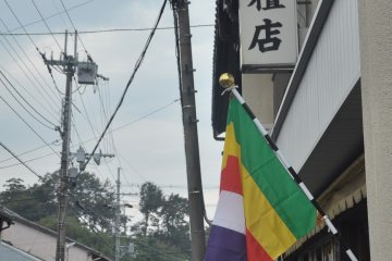 <p>The coloured flag relates to Buddhism</p>