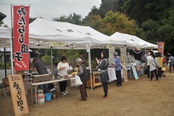 <p>In an emptied car park, a food court is set up for people to rest and eat</p>