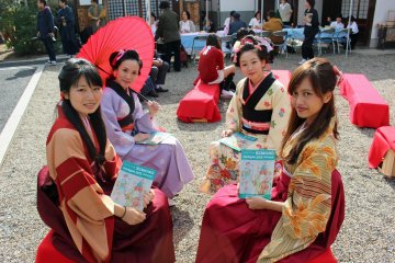 <p>Kimono clad students from the Nara University of Medicine hold up the Jazzgle's event booklet &nbsp;</p>