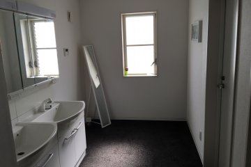 <p>A long mirror at the hallway</p>