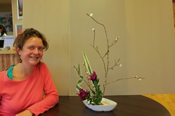 <p>A French participant shows off her creation, an expression of the November autumn season</p>