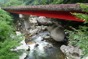 a bridge with clear rapids undernealth