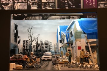 <p>This one shows the destruction and how people were helping each other and praying for the deceased. Blue plastic sheets covered the roofs to shelter from rain.</p>