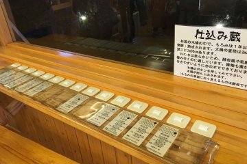 <p>You can press these buttons to light up the respective barrels to see the colour of the unrefined soy beans as they are undergoing fermentation for up to a year.</p>