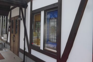 <p>A couple of colourful windows by the entrance</p>
