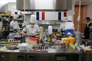<p>The kitchen can be viewed from a window in the large dining room.</p>
