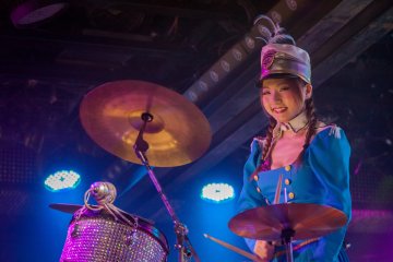 <p>A drummer accompanying the marching band on a float</p>

