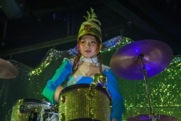 <p><span style="line-height: 20.8px;">A drummer accompanying the marching band on a float</span></p>
