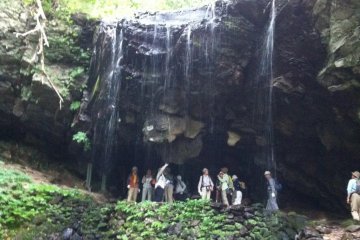 People gathered inside the waterfall