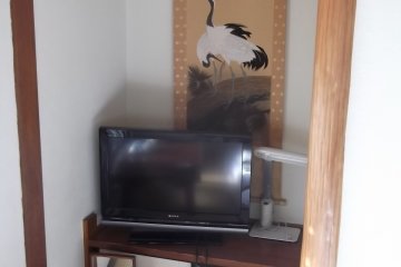 <p>The TV and scroll in another of the guest rooms</p>
