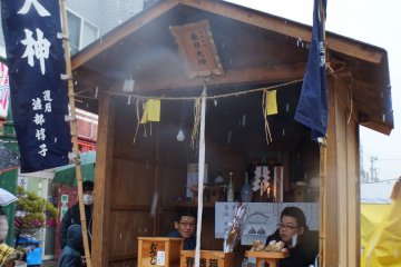 <p>A small portable shrine selling good luck charms and accepting donations.</p>
