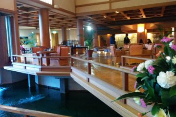 <p>Carp swim freely in the waters beneath the elevated cafe</p>

